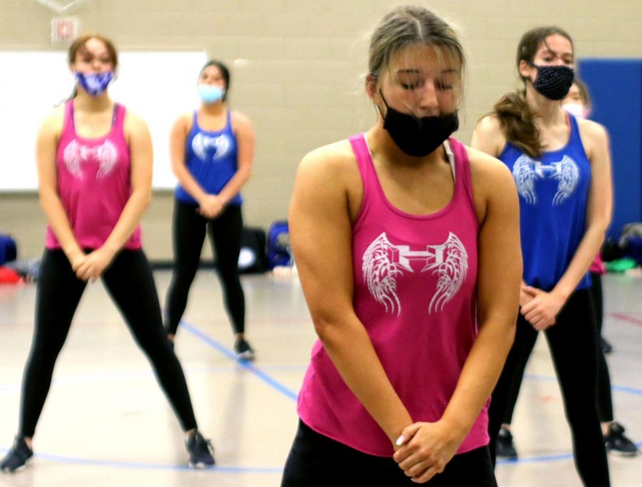 Silver Wings captain Corinne Kiesling poses with the rest of her team before starting a dance during rehearsal. The seniors will be spotlighted more in the show, as it is their last one before they graduate. “We really want to make our show the best we can, especially for the seniors,” Kiesling said.