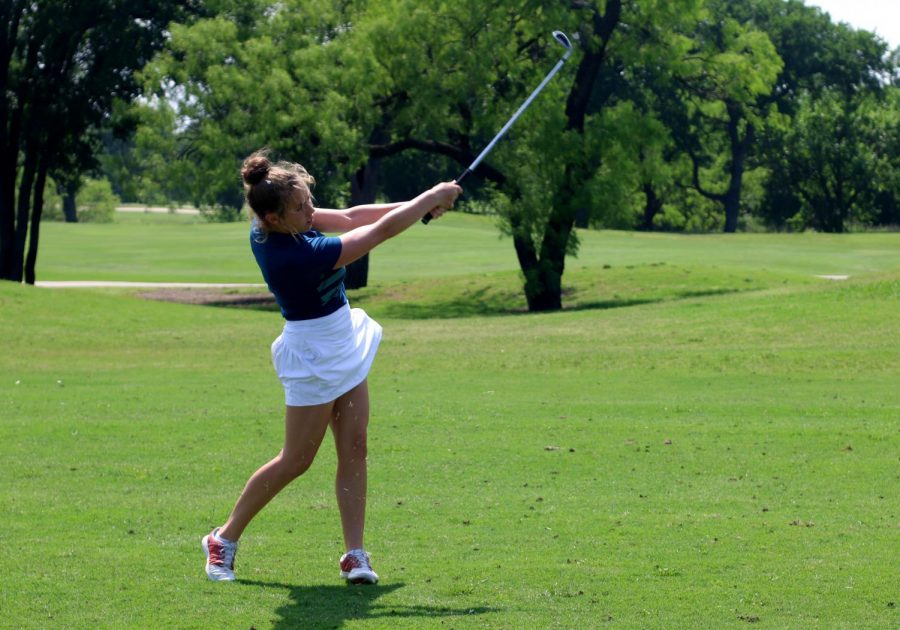  Senior Gracie Tribolet follows through after hitting the golf ball at a practice prior to the state tournament. This year was Tribolet’s fourth year on the golf team