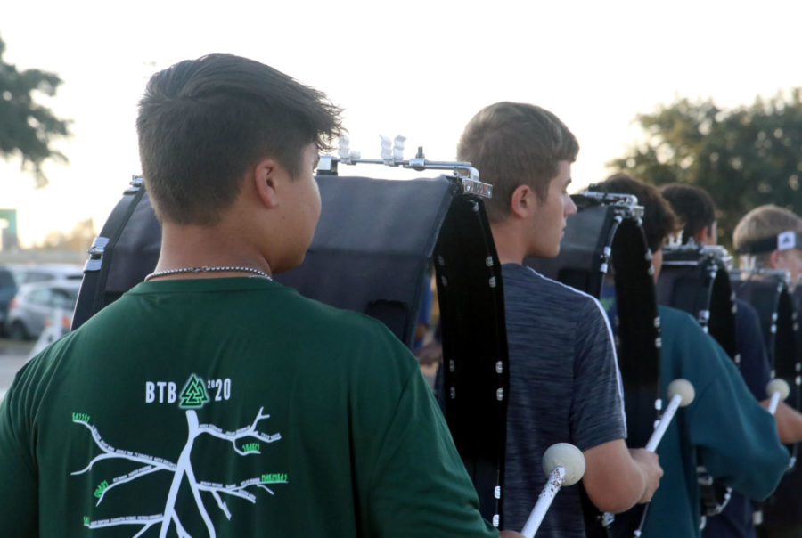 Junior Jack Rossi practices with the drumline before school on Sept. 17. Rossi plays Bass 5, the largest bass drum, and is also the co-leader of the band’s media team. 