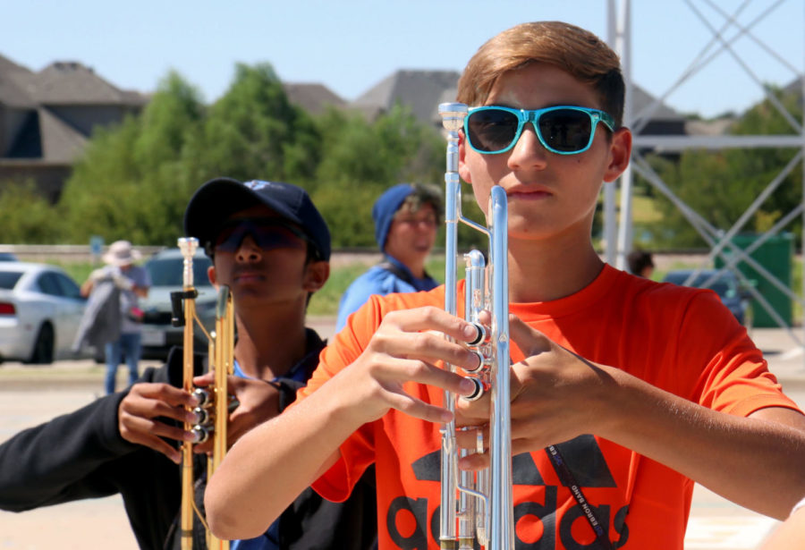Sophomore Jack Strahan and freshman Nikhil Pimpalapure march during class on Sept. 22. Volunteers for the food drive will collect donations next to the Hebron Band trailer, which is parked outside of the band hall and auditorium.