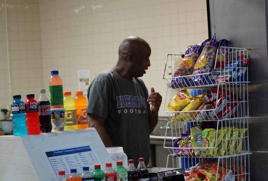 Ulysses Wright, the head of the Hebron football concessions, provides snacks and drinks to customers at the Hawk Stadium on Oct. 7.