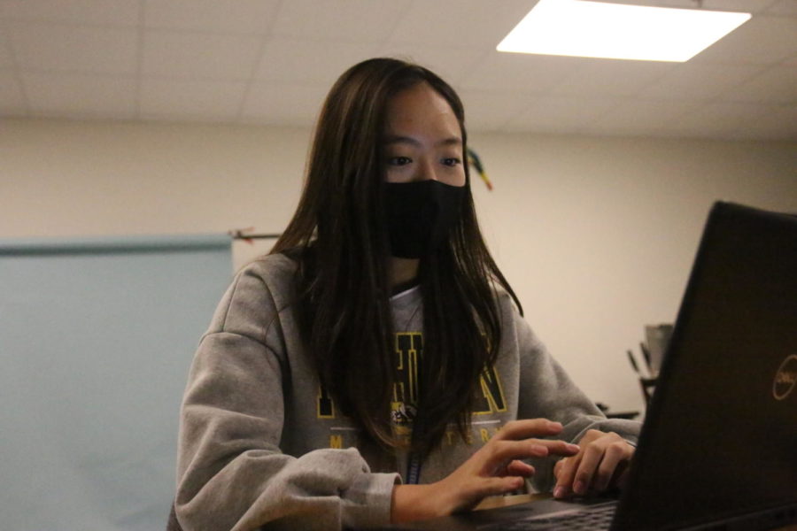 Elena Hong, a junior, begins to plan what she will be tutoring children in during her weekly Saturday sessions.