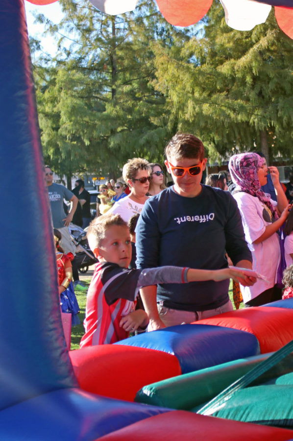 A child participates in the magic ball carnival game to win prizes that included stuffed animals. Near the end of the event, organizers played the movie “Hocus Pocus.”
