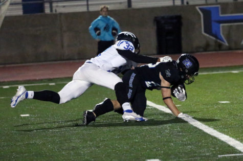 Running back Lane Haworth is tackled after running the ball downfield during the Plano West game on Oct. 29. The Hawks beat Plano West 47-35.
