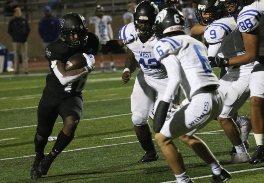Running back Brian Nwokike runs the ball for a first down during the fourth quarter against Plano West on Oct. 29. 
	
