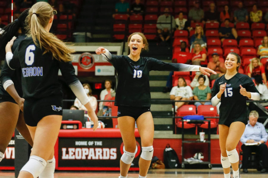 Sample and her teammates celebrate after scoring a point.