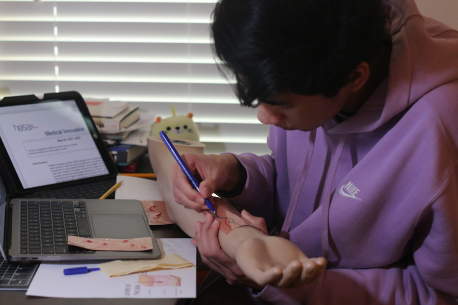 Senior D’Marco De Leon prepares the visuals for the Area Leadership Conference. Students will compete in many rounds of judging in hopes to advance to the State and International level.