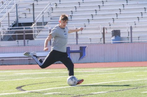 Senior captain Sean Simpson kicks the ball toward a goal during practice on Jan. 21. The team practices every day during the 4th period.