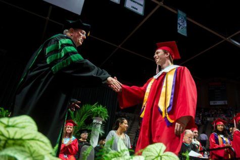 Dr. Kevin Rogers shaking the hand of an LISD graduate. Photo via LISD