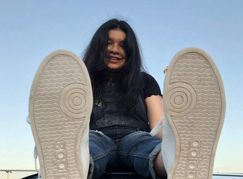 Senior Samin Budhwani sits on top of her car during senior sunrise on Aug. 30.