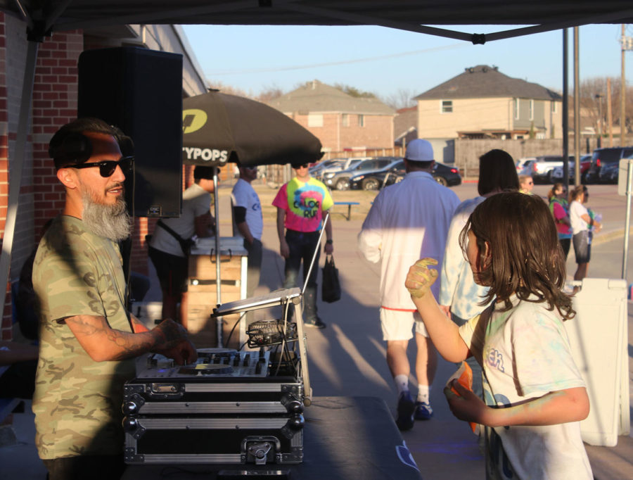 A DJ was featured and led the color run through announcing the different parts of the run on the microphone. The DJ announced important information about the color run as well as provided music. 