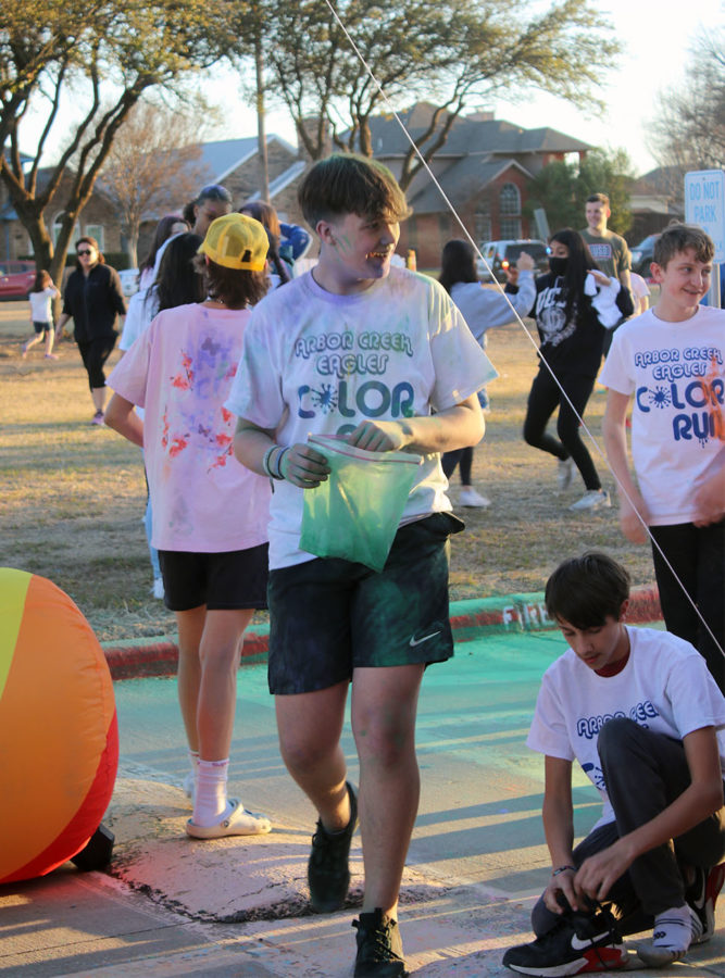 Eighth graders wrap up and get ready to leave as the color run ends. Students continued to run and throw their own color bombs at each other even after the run ended.