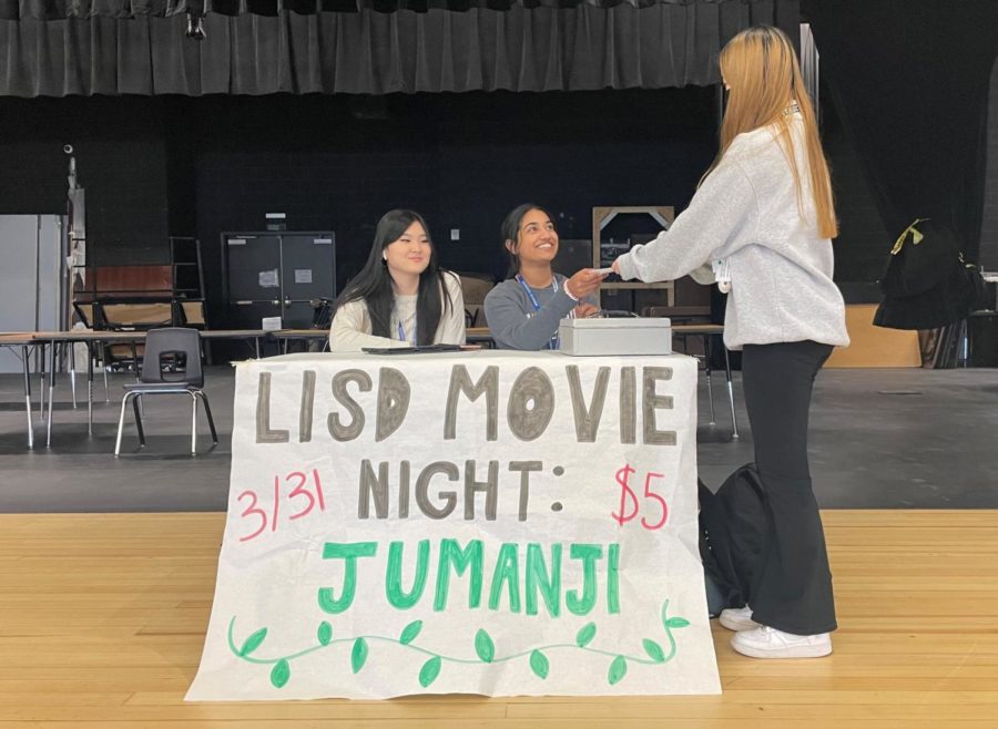  Junior Elizabeth Kang (left) and sophomore Serai George (right) sell tickets for the movie night during B lunch on March 30. Tickets are on sale for $5 during every lunch leading up to the event.
