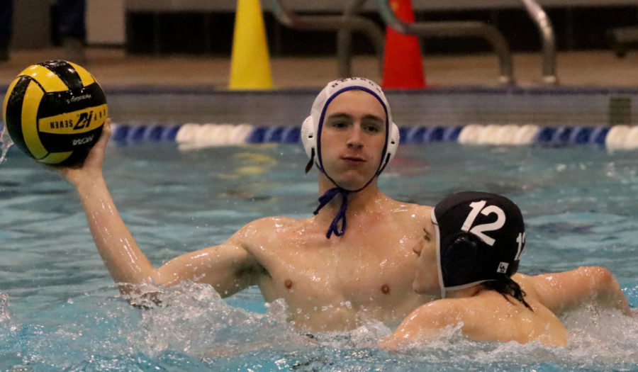 Senior Tyler Davis prepares to throw the ball past a Rock Hill player at the Hebron game night on March 22.