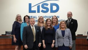 Dr. Lori Rapp (front center) poses with the LISD Board of Trustees at the Feb. 15 meeting. At the meeting, board members went around to give remarks on the selection of Rapp as superintendent. Rapp then gave remarks, took photos with others and signed the contract with the board president. 
