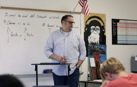 Honors pre-calculus and AP calculus AB teacher Bradley Barry teaches his students calculus during his third period class.