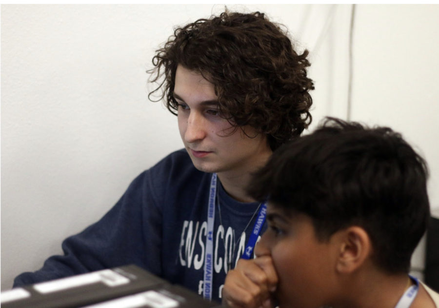 Senior Jackson Halvorsen and sophomore Akshay Kondola watch a game play out on the computer screen during fourth period. Esports officially became a class in 2021.