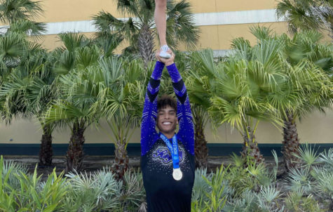 Junior Landon Hill lifts a cheerleader up and poses for a photo after winning world championships on April 23-24. 