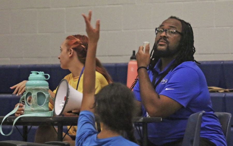 Color guard director Chris Josey directs practice on Sept. 1. During the fall semester, the guard works with the band, and during the spring semester, they separate for winter guard season. 
