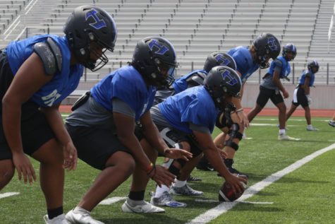The offensive line prepares to snap the ball at practice during fourth period on Aug. 31. With the major loss against Jesuit, the team has been practicing heavily on their offensive plays.