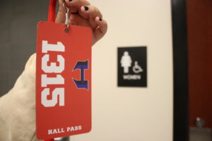A hall pass in front of the women’s restroom in the 1300 hallway.