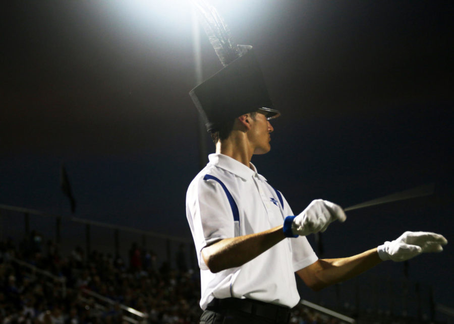 Steven Solis-Welch directs the band during the halftime show at the football game Sep. 2. Solis-Welch had a marching spot last year as a freshman, but had to give that up to direct.