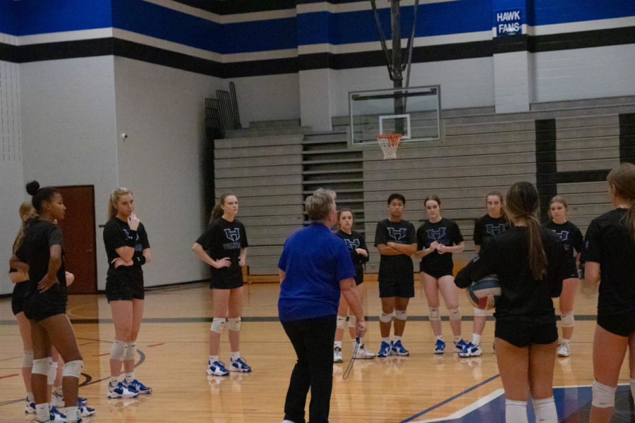 Coach Karin Keeney gives team pep talk before their next drill called “The Wave” at practice on Oct.13. The drill involves two serving and passing groups that play against each other. The goal of the passers is to get five passes in two minutes without over-passing or letting the ball hit the floor, while the goal of the servers is to “attack” the opposing passers.