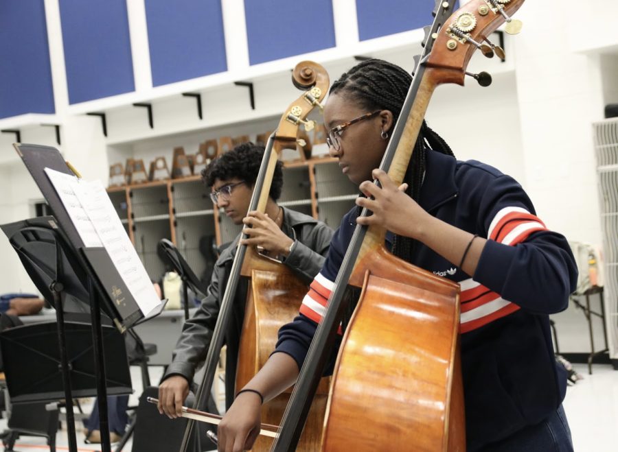 Senior+bassists+Daniel+Abraham+and+Jordyn+Stovall-Finch+play+with+the+chamber+orchestra+on+Oct.13.+The+group+played+through+their+pieces+for+Texas+Music+Educators+Association+before+playing+through+their+cluster+concert+music.%0A