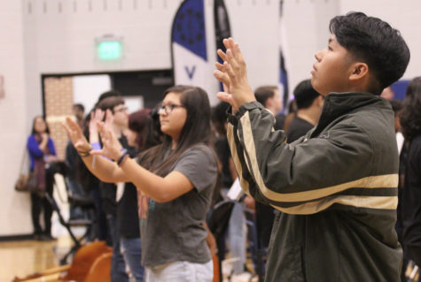 Junior Jerick Antonio, a member of the school’s Signing Hawks, signs the national anthem to the crowd. The Signing Hawks go to many events to sign the national anthem including football games and pep rallies.