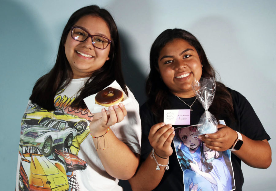 Valerie Rodriguez (left) and Kayla Melgar (right) hold up baked goods.
