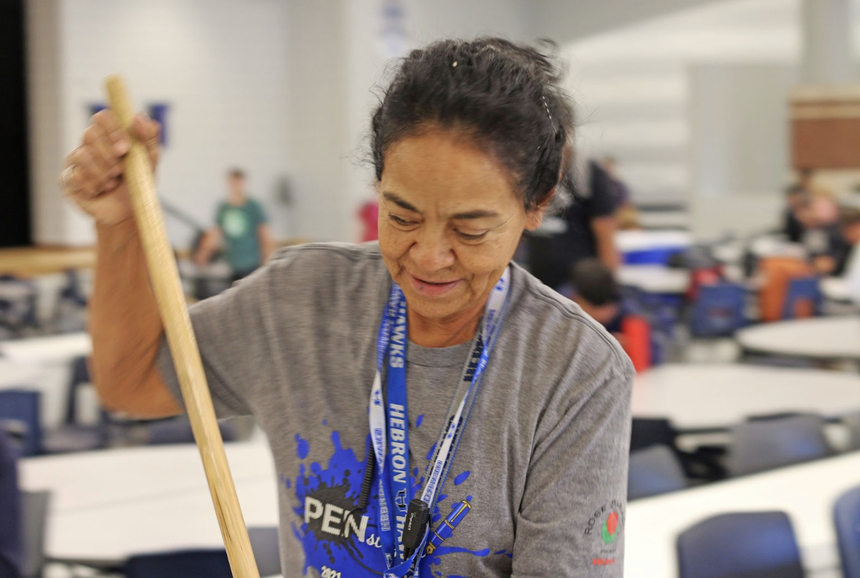 Janitor Maria Arriaga cleans the cafeteria at the beginning of D lunch. She cleans for around ten minutes between every lunch and does a final sweep after all students have left. 