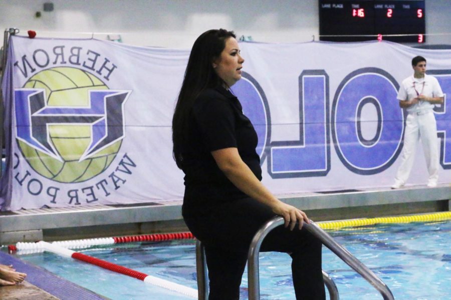 Assistant water polo coach Sarah Carlile watches the JV boys team play against Marcus on Sept. 9 at the LISD East Aquatic Center. Carlile has been involved in the sport since she was a freshman in high school.