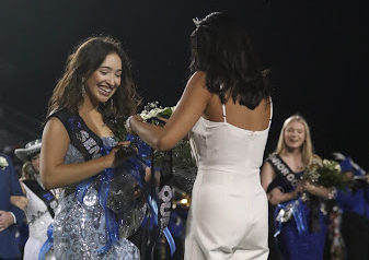 Senior Isabella Nations is crowned the homecoming queen by last year’s queen Kaitlyn Hoang at halftime of the homecoming football game on Sept. 23. As a band officer and section leader, she had just finished marching with the band in her sparkly, floor length dress.
