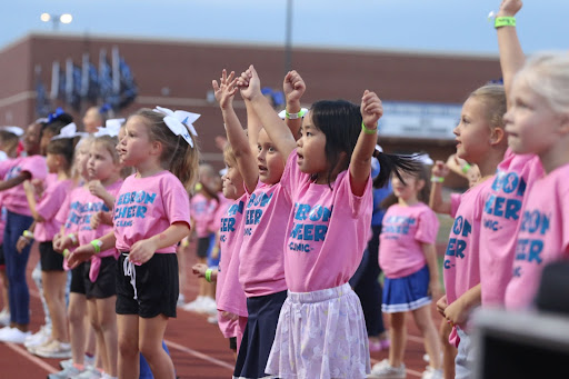 Children from the cheer clinic rehearse cheer during the first quarter. The clinic was held on Oct. 1 and consisted of varsity cheerleaders teaching cheers and playing games with elementary schoolers. 