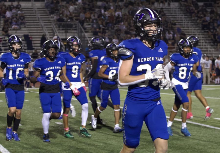 Sophomore linebacker Luke Sharp leads other players in running off the field after the second quarter of the game on Oct. 14. The team played Flower Mound and won with a score of 38-14.