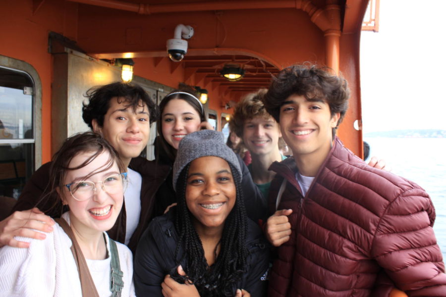 Junior Sophia Wheeler and sophomores Christian Soriano, Riley Unterbug, Maya Ware, Shane Duggan and Keane Nair (left to right) pose on the Staten Island ferry. After doing workshops all day, they went on a ferry to see the Statue of Liberty.
