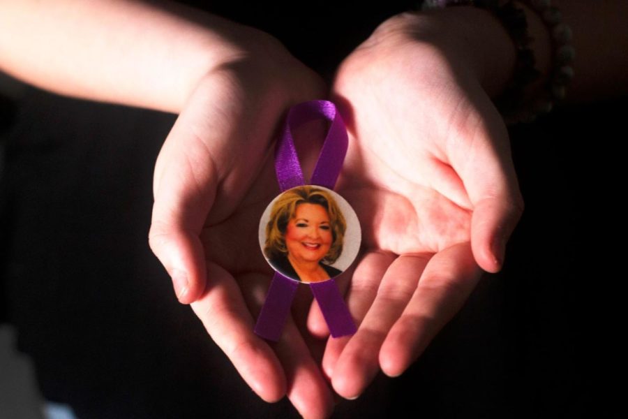 Peyton+Kuschmeider+holds+the+purple+ribbon+with+a+photo+of+her+late+grandmother.+The+ribbon+was+worn+at+her+grandmothers+funeral.