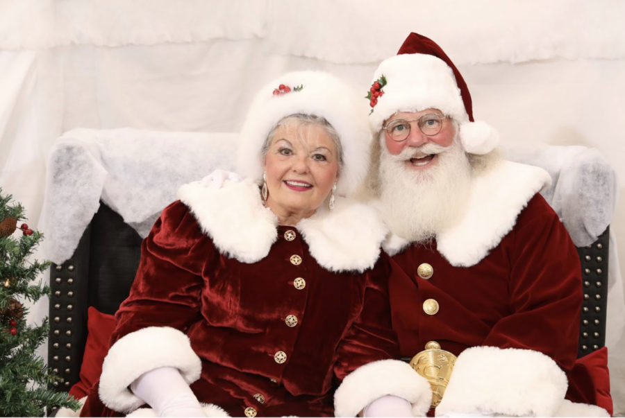 Helena and Leon Isbell pose for a picture at a company holiday party for Keller Williams North Country Realty on Nov. 22. The couple have worked with a numerous number of children, taking special interest in helping children with autism experience the magic of Christmas.