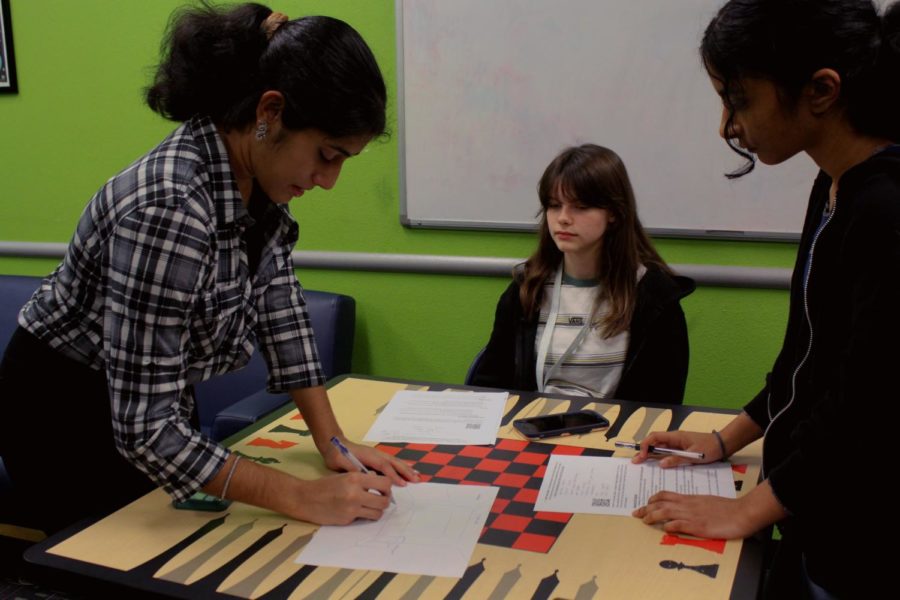 Senior Ann Jayan, sophomore Jayden Davis and freshman Anjali Abraham brainstorm ideas for the teen room at the third Teen Advisory Council meeting on Dec. 5. Upon discussing the desired changes, the council members did research on what they wanted to add before logging it down on a Google Sheet, due by Dec. 16. 