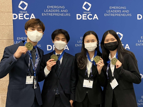 (left to right) Seniors Joseph Kim, Beomjun Kim, Chloe Yean and Lisa Choi pose with medals at the district meet. They all advanced to state last year and won in their roleplay events at DECA district.
