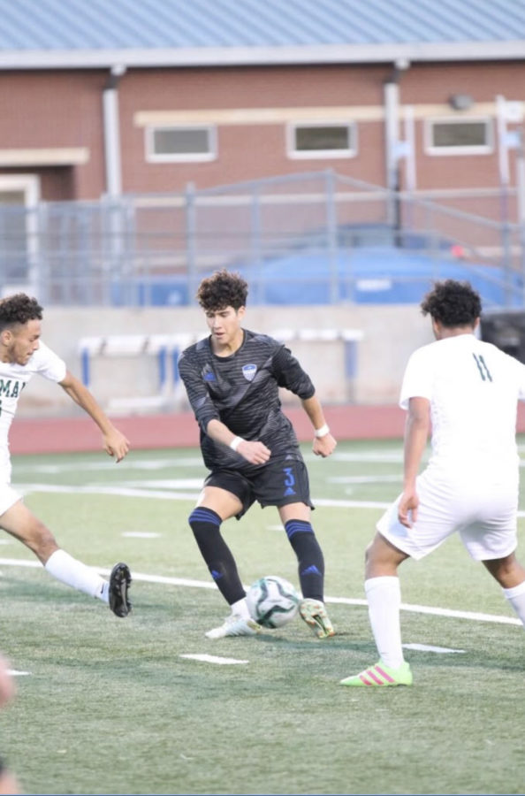 Senior Evan Kelley dribbles the ball through defenders at a game