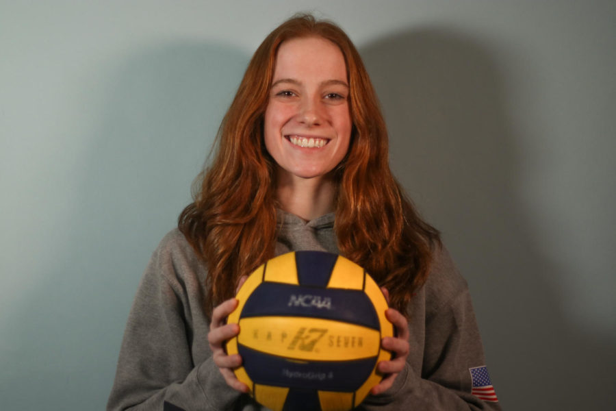 Water polo co-captain Avery Gallucci poses with a signed water polo ball. After high school, Gallucci plans on playing water polo in college and potentially making a career out of her love for the sport.
