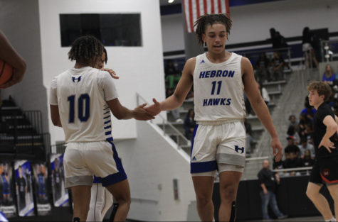 Junior Cameron Mennsfield and senior Jaden Clemons shake hands during a game against Marcus on Jan. 13. The team won the game 67-40.