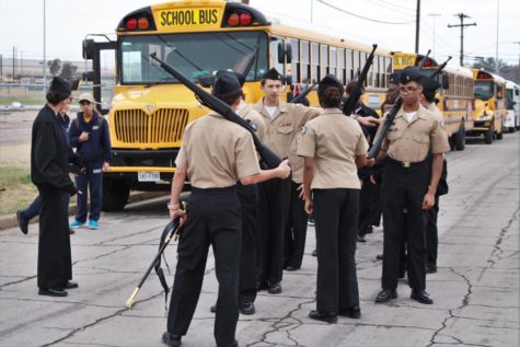 Cadets prepare in front of buses as they wait for the armed drill march at the Waco meet Jan. 28.