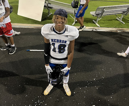 Sophomore JJ Hatcher poses for a photo on the sidelines during a football game. 