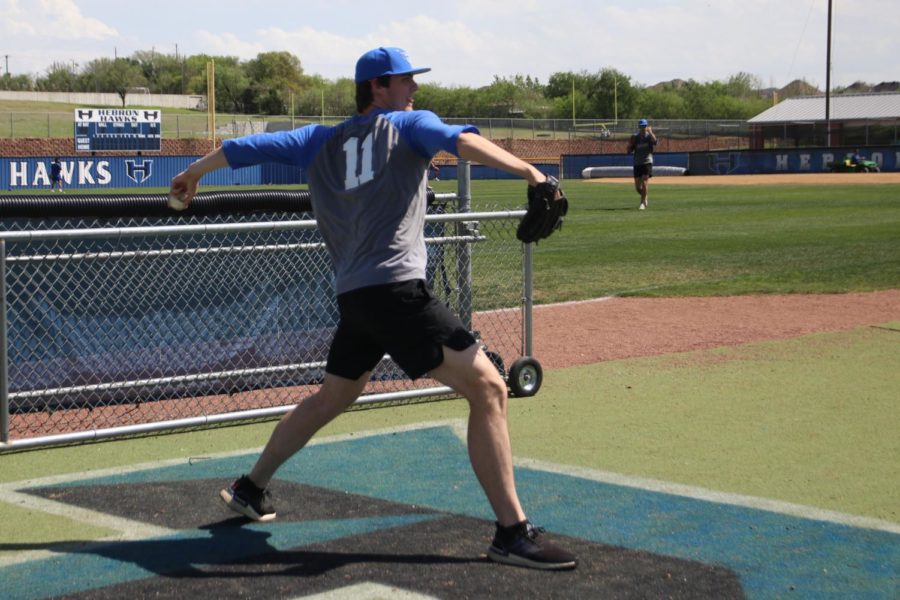 Senior pitcher Will Patterson works on his pitching during practice on March 31. The team has been focusing on the style of play that Marcus typically uses as well as practicing their strengths, like pitching.