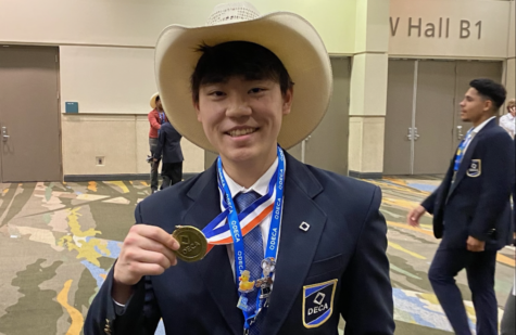 Junior Randy Song poses with his medal after placing top 10 at the DECA International Center.
