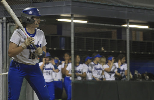 Senior Zoe Bowen stands in the batter’s box as her team cheers for her on March 6. The team played Marcus and won 8-1.