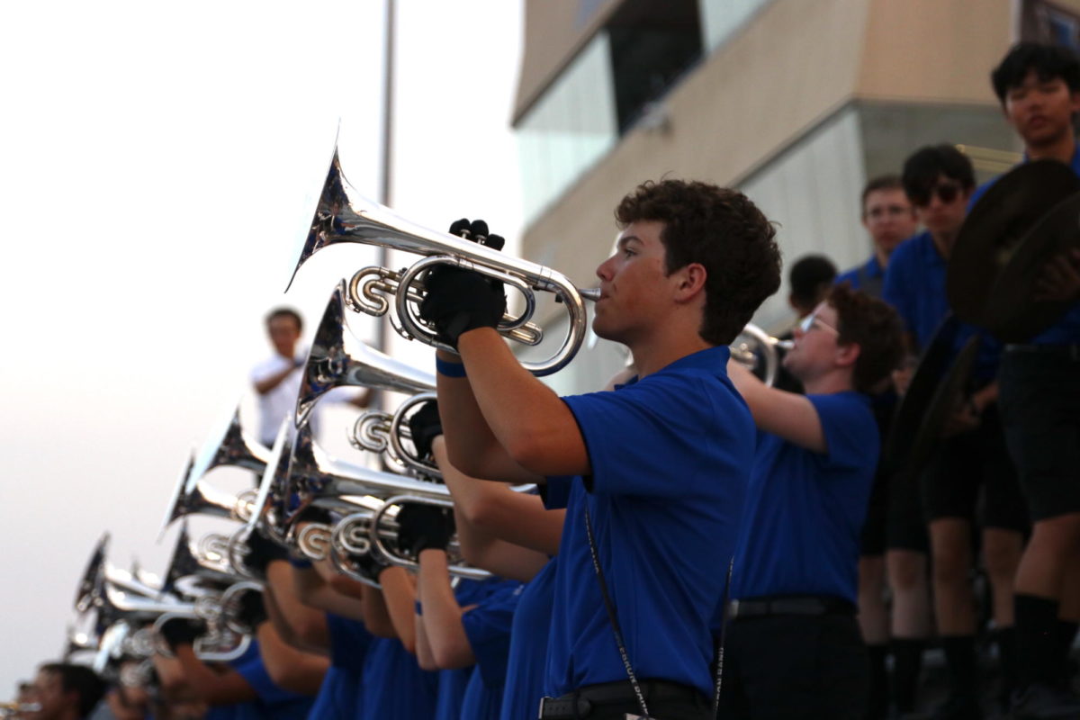 Sophomore Gavin Shand performs with the band in the stands. The band performed a multitude of stand tunes during the game and played the fight song after every Hebron touchdown.