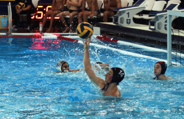 Sophomore Bogdan Slavu blocks the ball against Dallas Jesuit on Aug. 26 at the Dallas Jesuit Aquatic Center. The team participated in the Scot/Rangers Tournament and played Foster, then played Jesuit once more.
